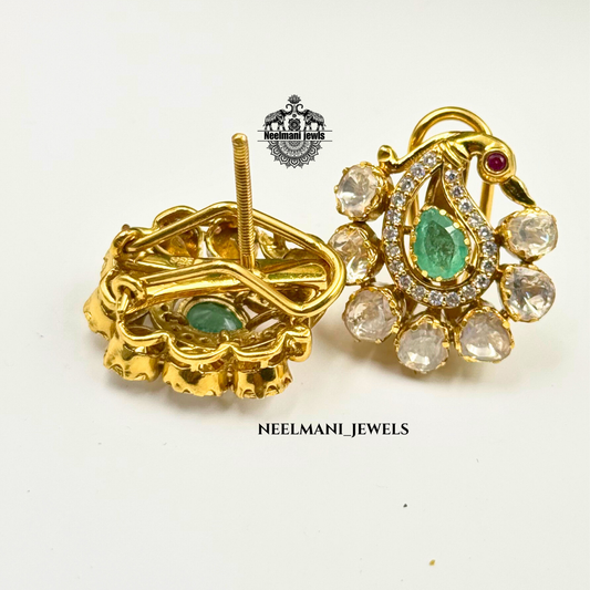 Gold earrings with green gemstones on a white background, branded 'Neelmani Jewels'.