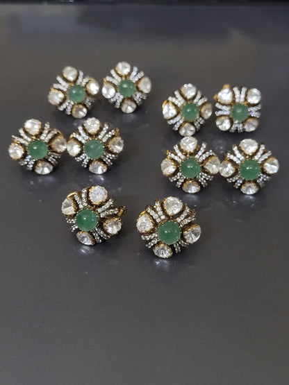 Gold and diamond earrings with red gemstones on a gray background