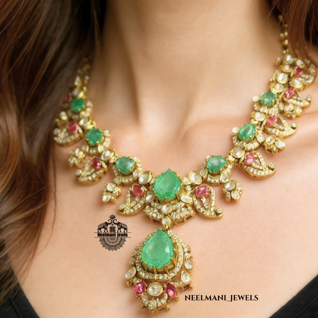Necklace with green and red gemstones on a model, featuring Neelamani Jewels logo.