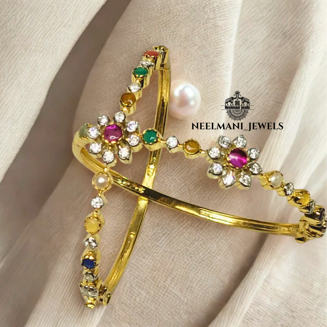 Gold bracelet with gemstones on a beige fabric background, featuring Neelemani Jewels logo.