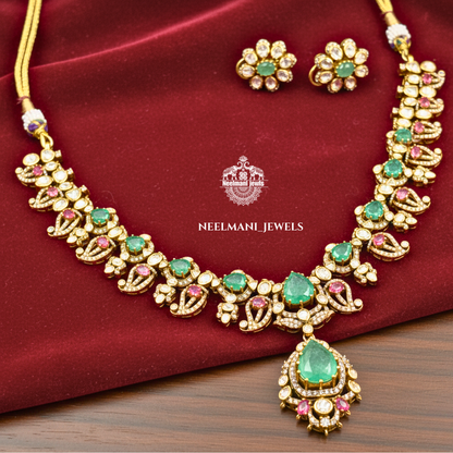 Neelamani Jewels necklace and earrings set on a red fabric background