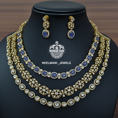 Necklace and earrings set with blue stones on a black stand, branded 'Neelamani Jewels'.