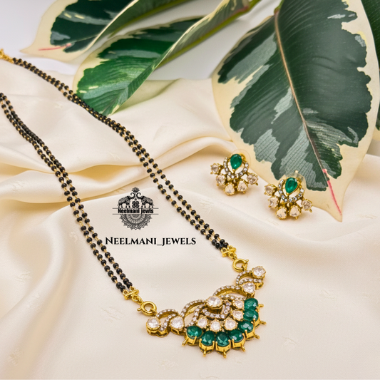 Neelmani Jewels mangal and earrings on a beige fabric with green leaves