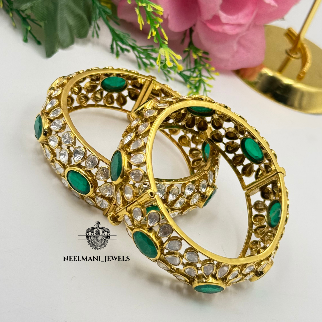 Moissanite polki bangle with green stones, branded as Neelmani Jewels.