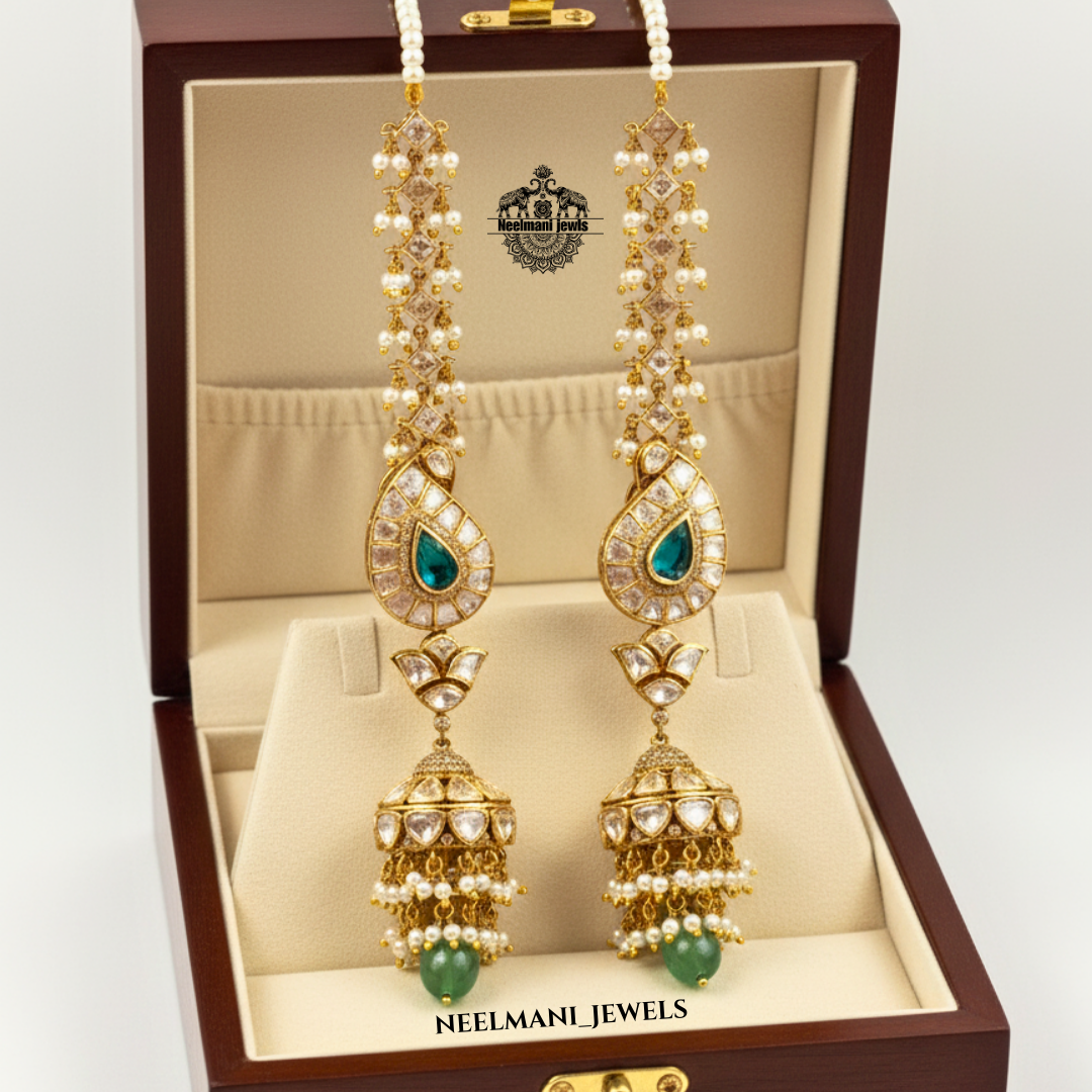 Gold and pearl earrings with green stones in a Neelmani Jewels.