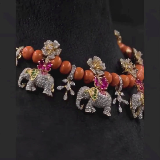 Statement ethnic jewellery with elephant motifs, coral-orange beads and sparkling floral designs